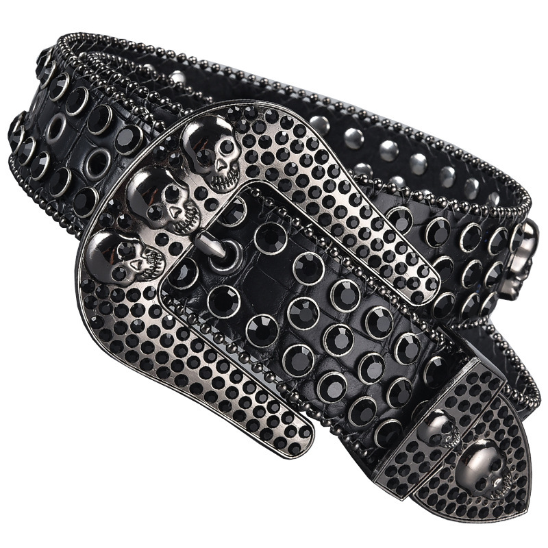 Black western belt with rhinestones, studs, and skull buckle details