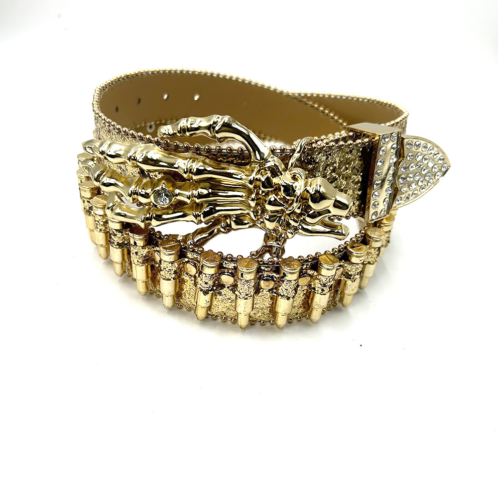 Gold glitter western belt with skeleton-hand buckle, bullet-inspired trim, and rhinestone accents