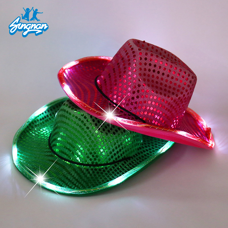Pink and green color-changing LED cowboy hats illuminated around the brim