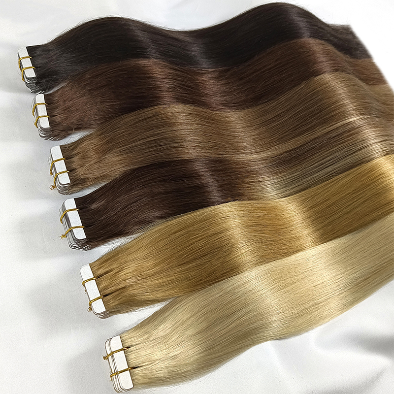 European 12A Virgin Tape-In Hair Extensions in multiple shades from black to blonde fanned out on white surface showing tape tabs