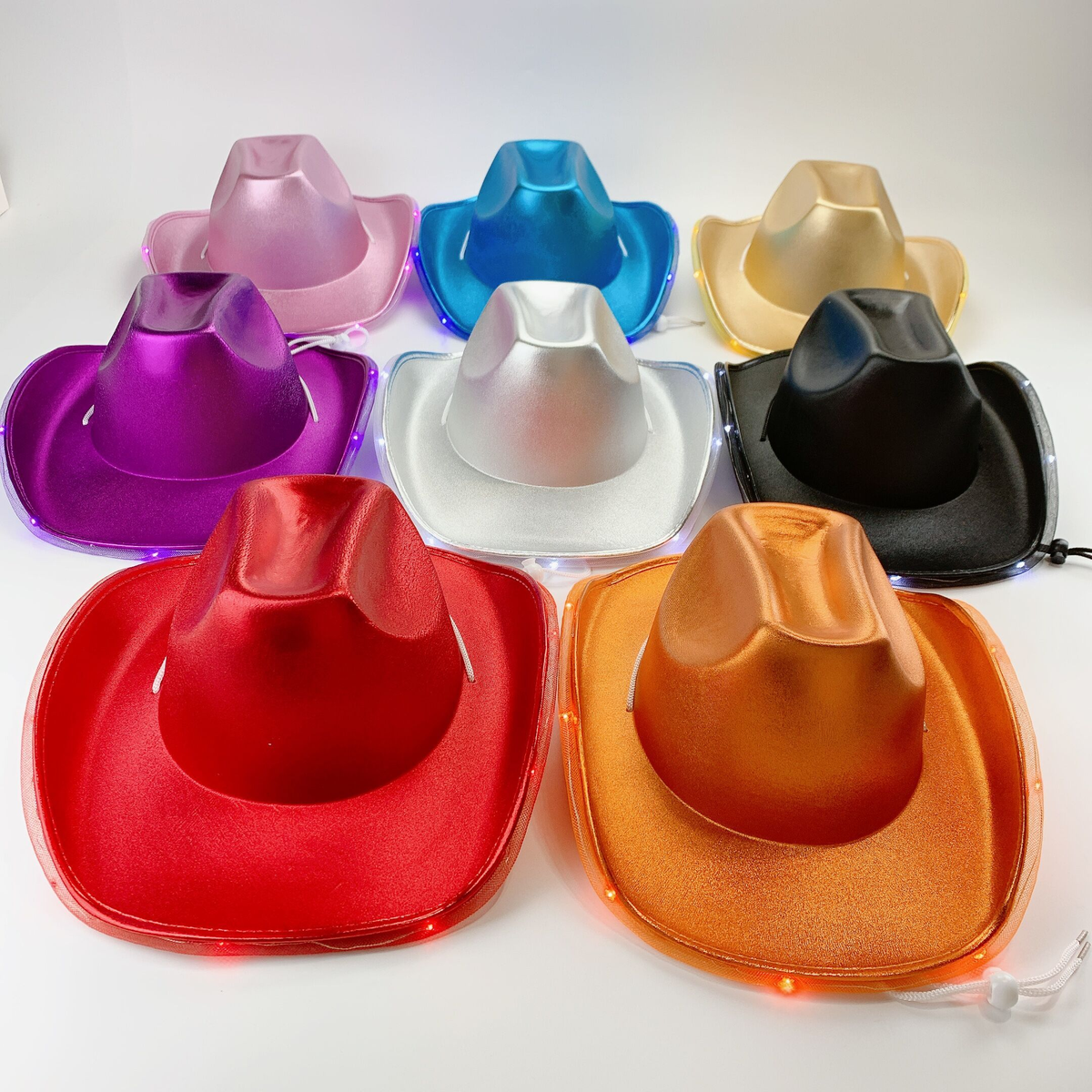 Colorful light-up cowboy hats displayed in red, white, blue, black, pink, purple, gold, and orange