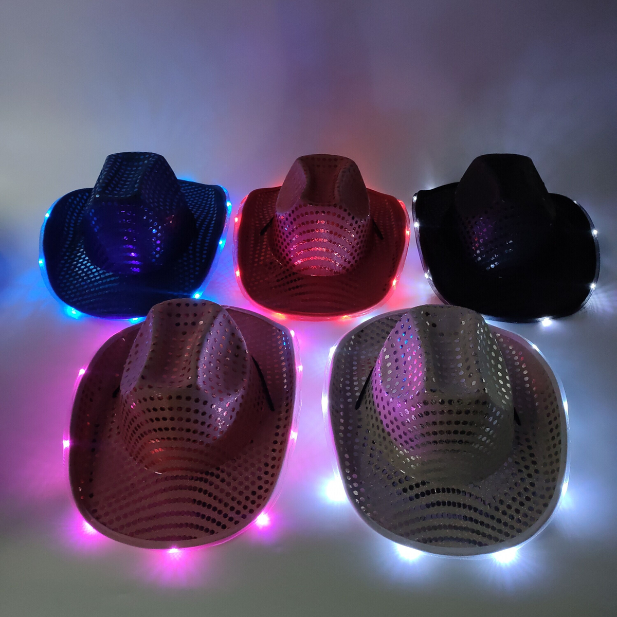 Assorted wide-brim LED cowboy hats glowing in blue, red, black, pink, and white